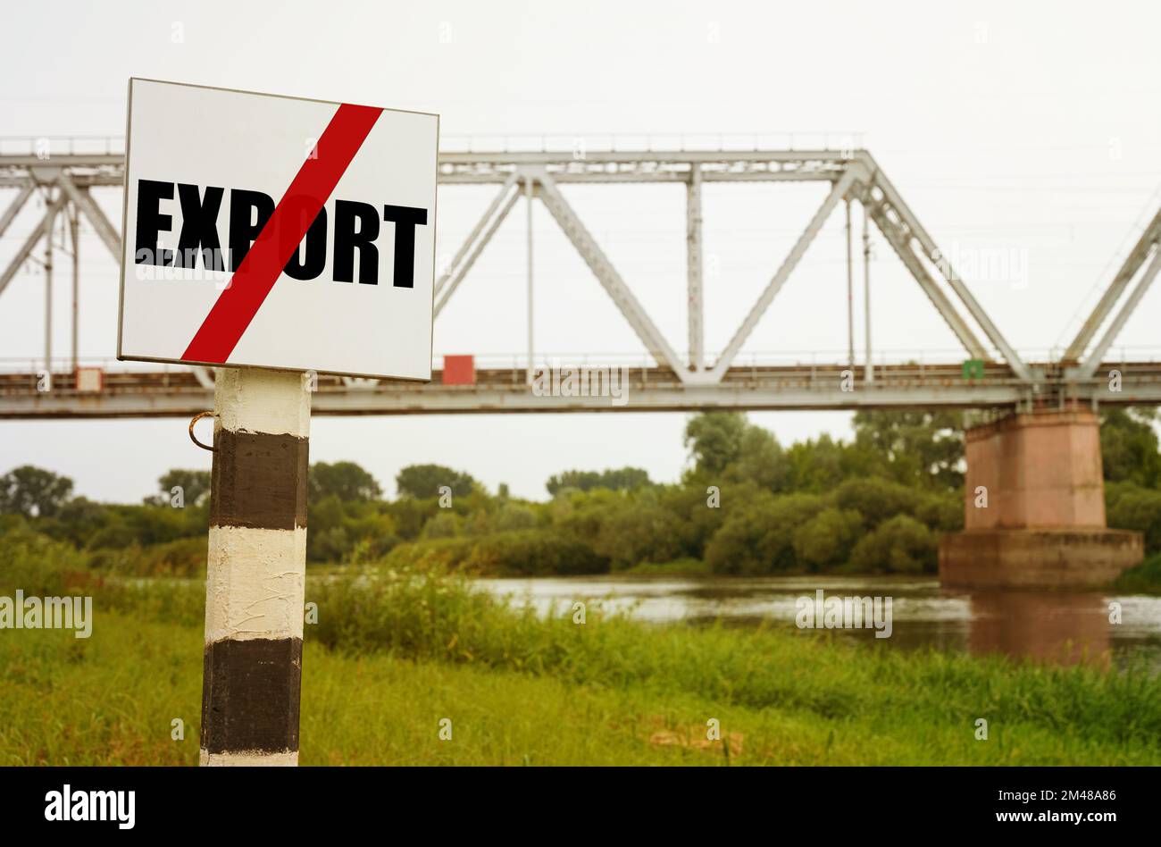 On the background of the railway bridge there is a sign with the inscription - NO EXPORT. Stock Photo