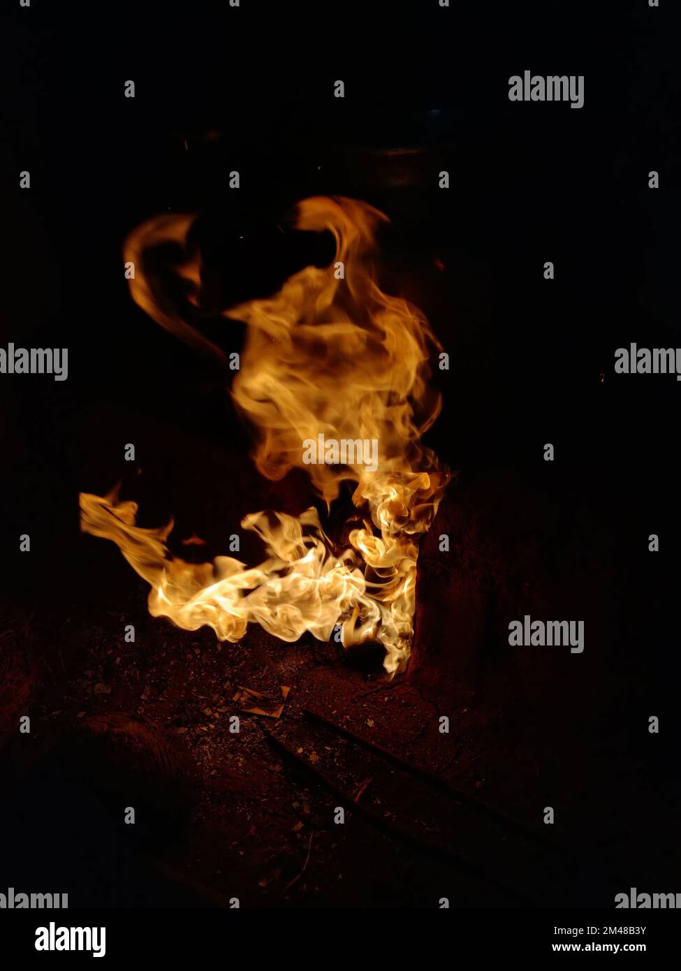 The fire on a dark background Stock Photo - Alamy