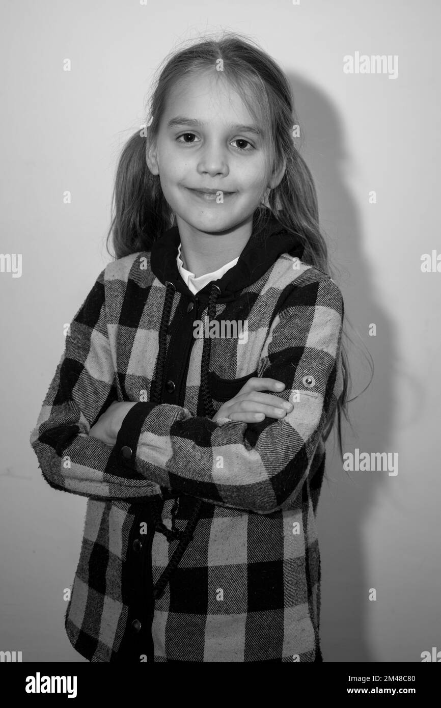 A girl in a checkered shirt on a white background Black and white photo