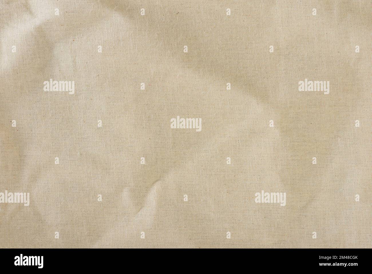 Texture of linen fabric in natural yellow color. The surface of the linen fabric as a background or banner, close-up. Stock Photo
