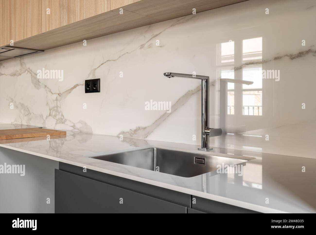 Closeup side view of contemporary design square metal sink embedded in