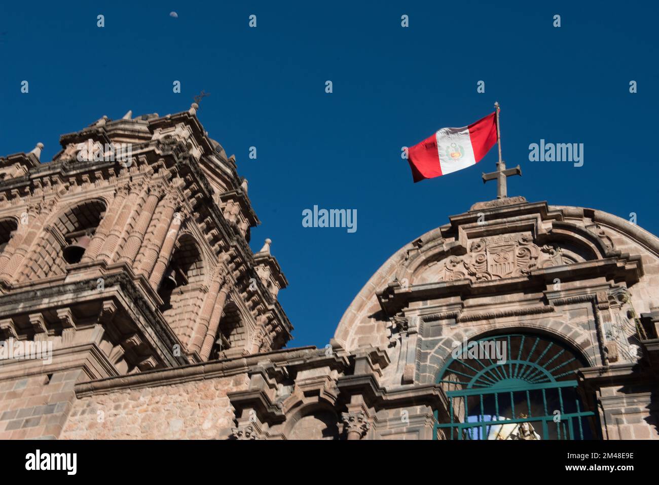 Peruvian flag against blue sky in Cusco Peru. Stock Photo