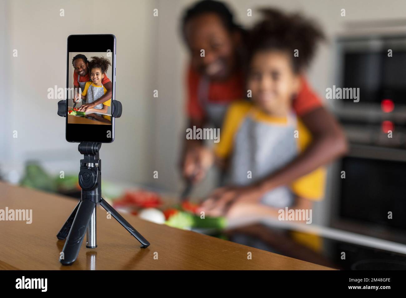 Black Father And Daughter Filming Content In Kitchen For Their Culinary ...