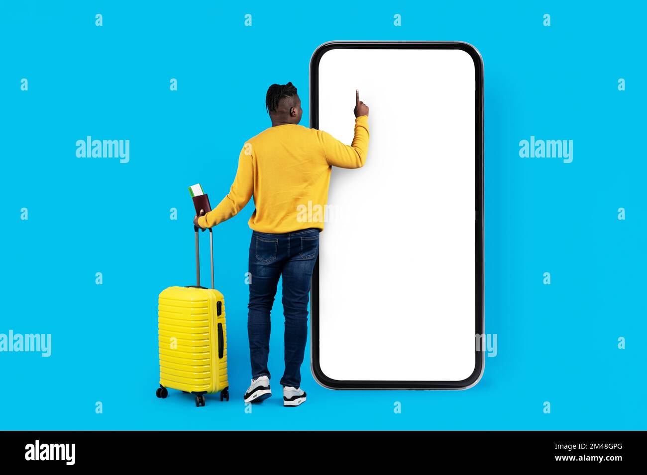 Black Man With Suitcase Using Big Blank Smartphone With White Screen Stock Photo