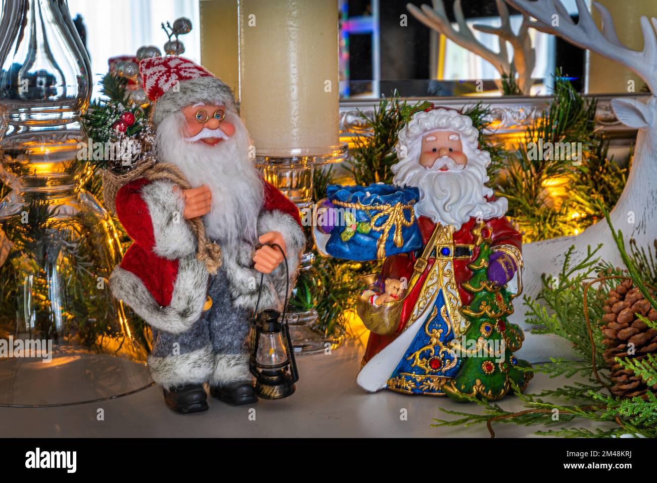 Christmas decorations. Santa Claus on the fireplace among other Christmas decorations. Stock Photo