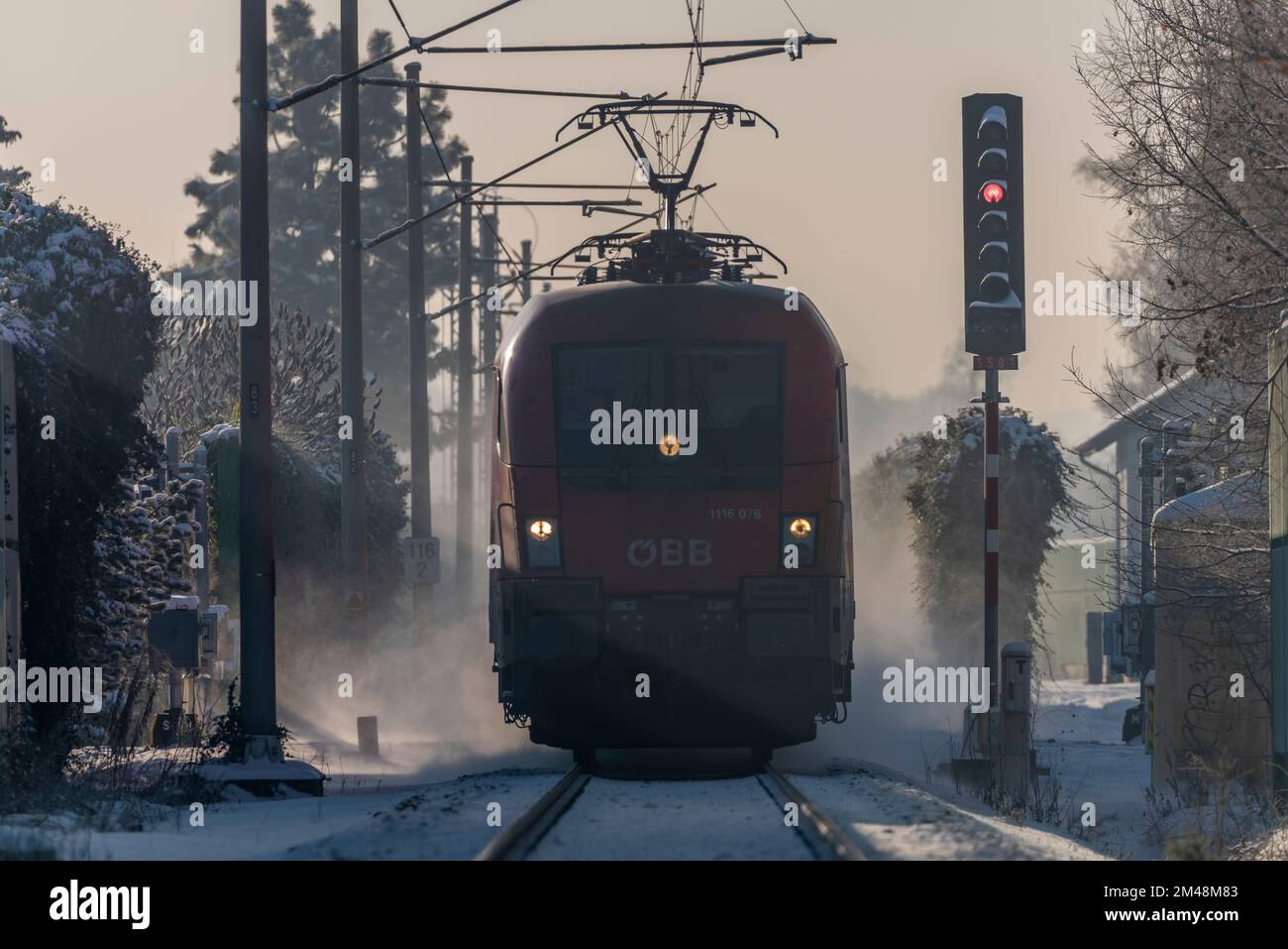 Red fast electric passenger train in frosty snowy winter morning near Budweis city Stock Photo