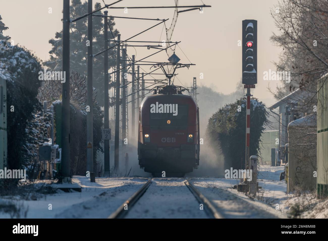 Red fast electric passenger train in frosty snowy winter morning near Budweis city Stock Photo