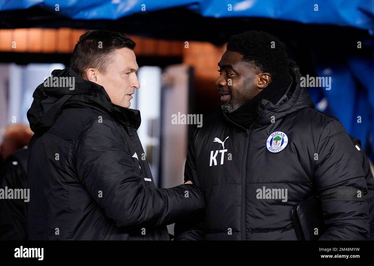 Wigan, England, 19th December 2022. Kolo Toure manager of Wigan Athletic (r) welcomes Paul Heckingbottom manager of Sheffield Utd  during the Sky Bet Championship match at the DW Stadium, Wigan. Picture credit should read: Andrew Yates / Sportimage Stock Photo