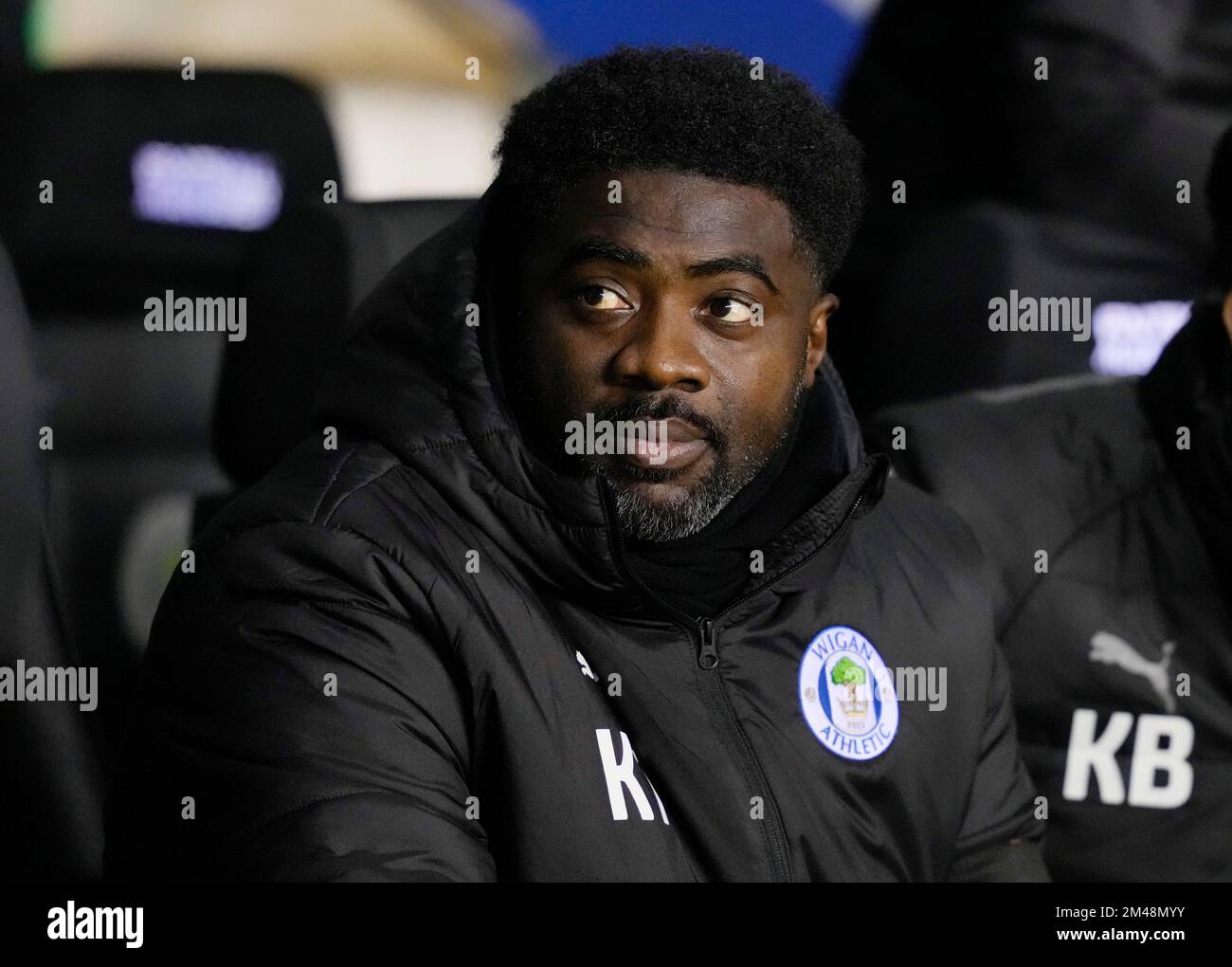Wigan, England, 19th December 2022. Kolo Toure manager of Wigan Athletic takes his seat for his first home game as their new manager during the Sky Bet Championship match at the DW Stadium, Wigan. Picture credit should read: Andrew Yates / Sportimage Stock Photo