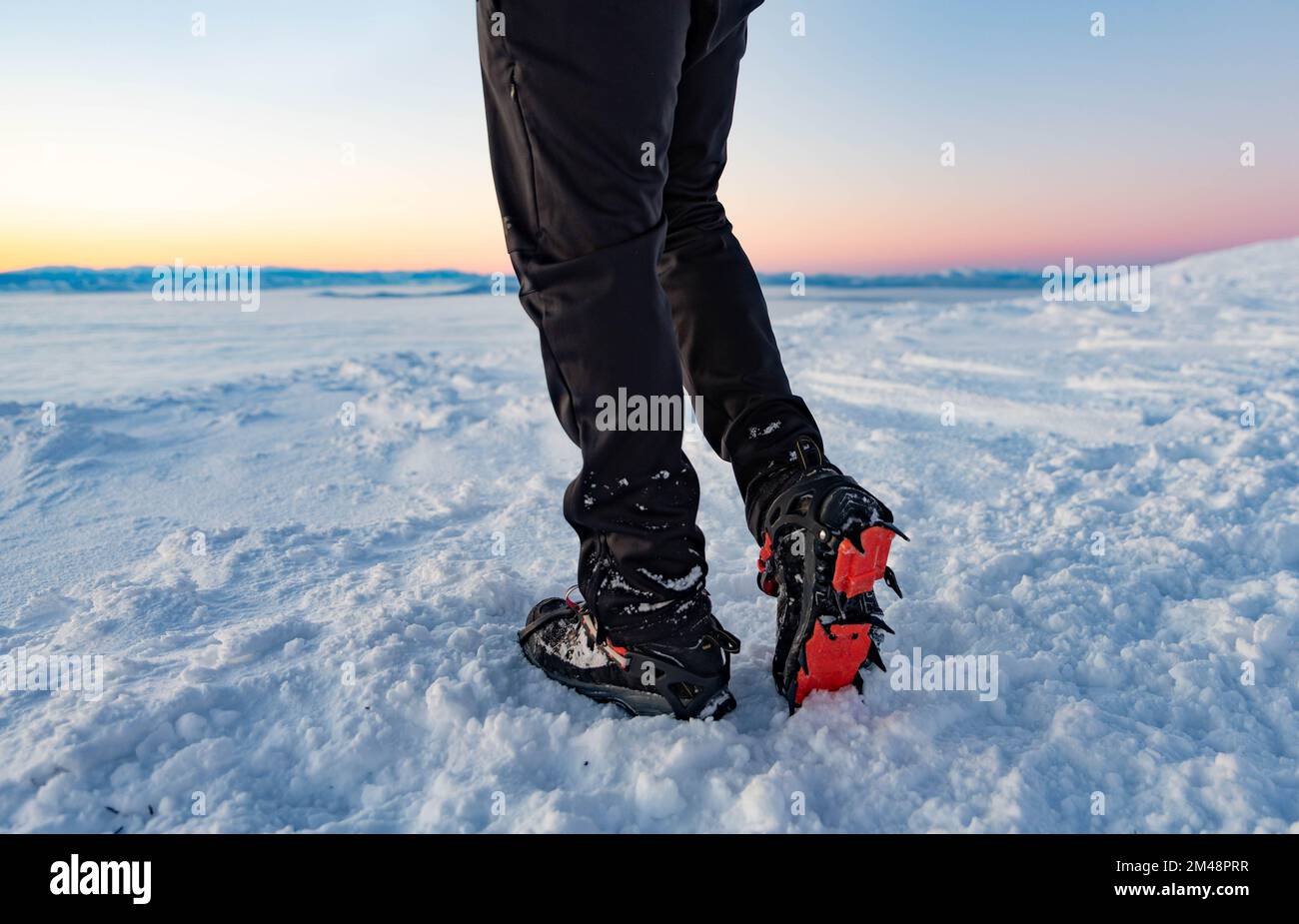 Mountain Boot with crampons on while hiking in the mountains in winter. Stock Photo