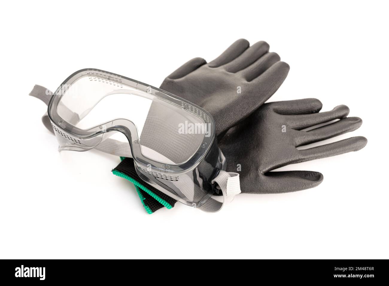 Protective safety glasses and work gloves isolated on white background. Industrial workwear Stock Photo