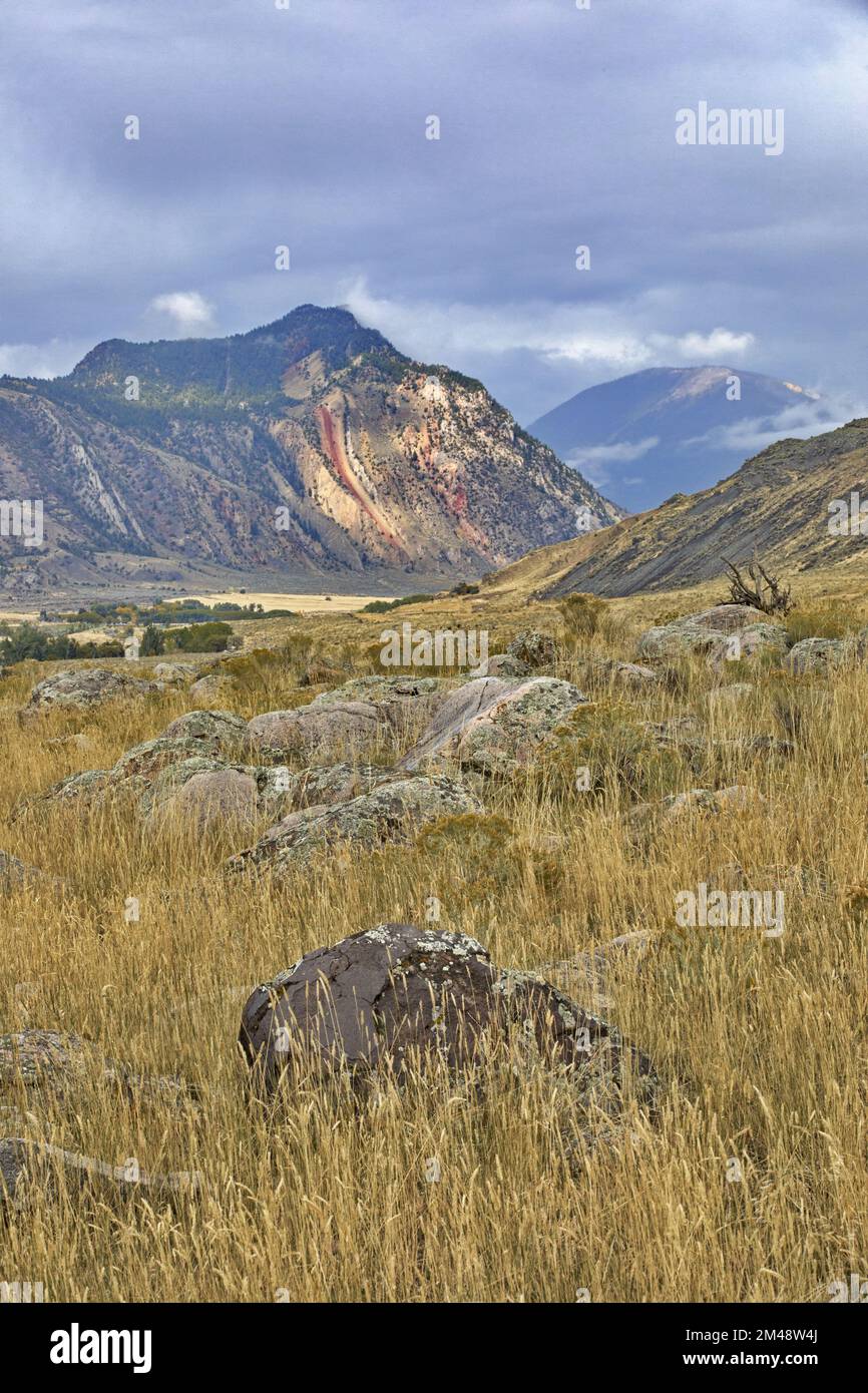 Picturesque vertical landscape with foreground rock accent to mountains ...