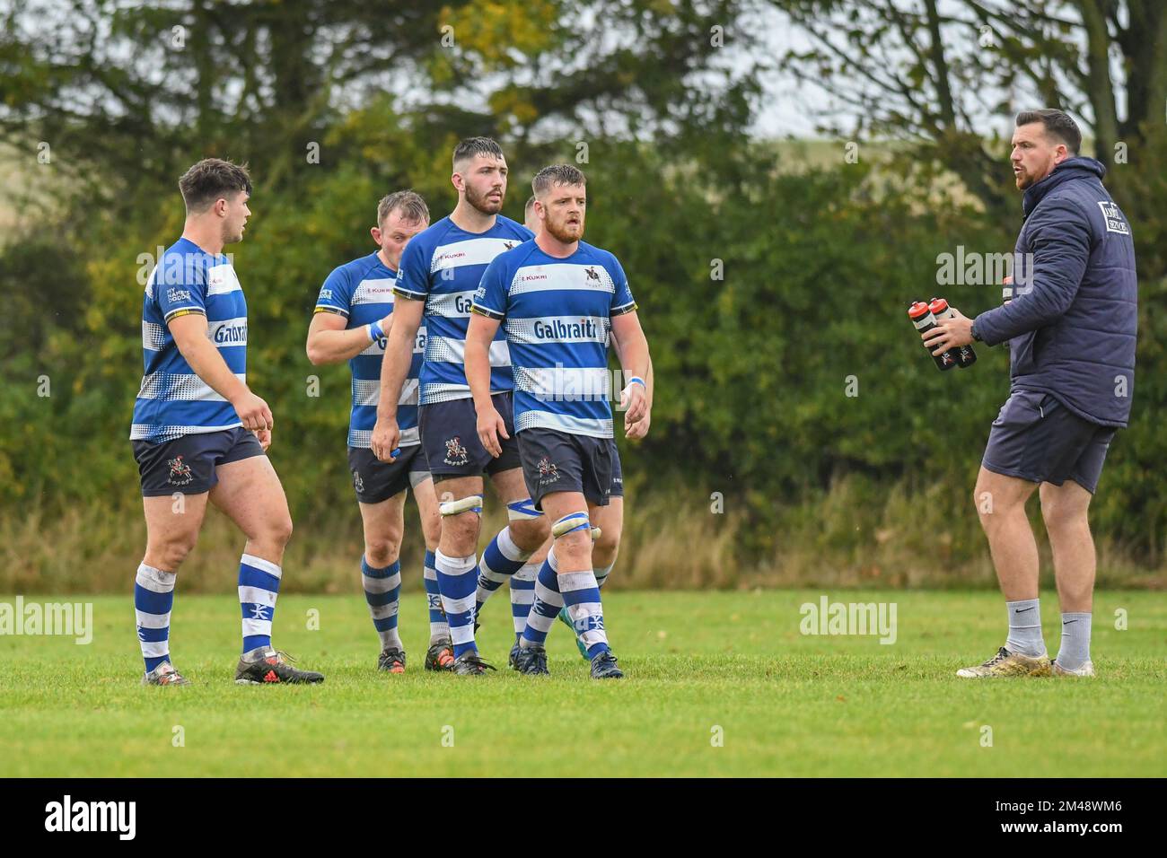 Howe of Fife players walk in a group towards water carrier during
