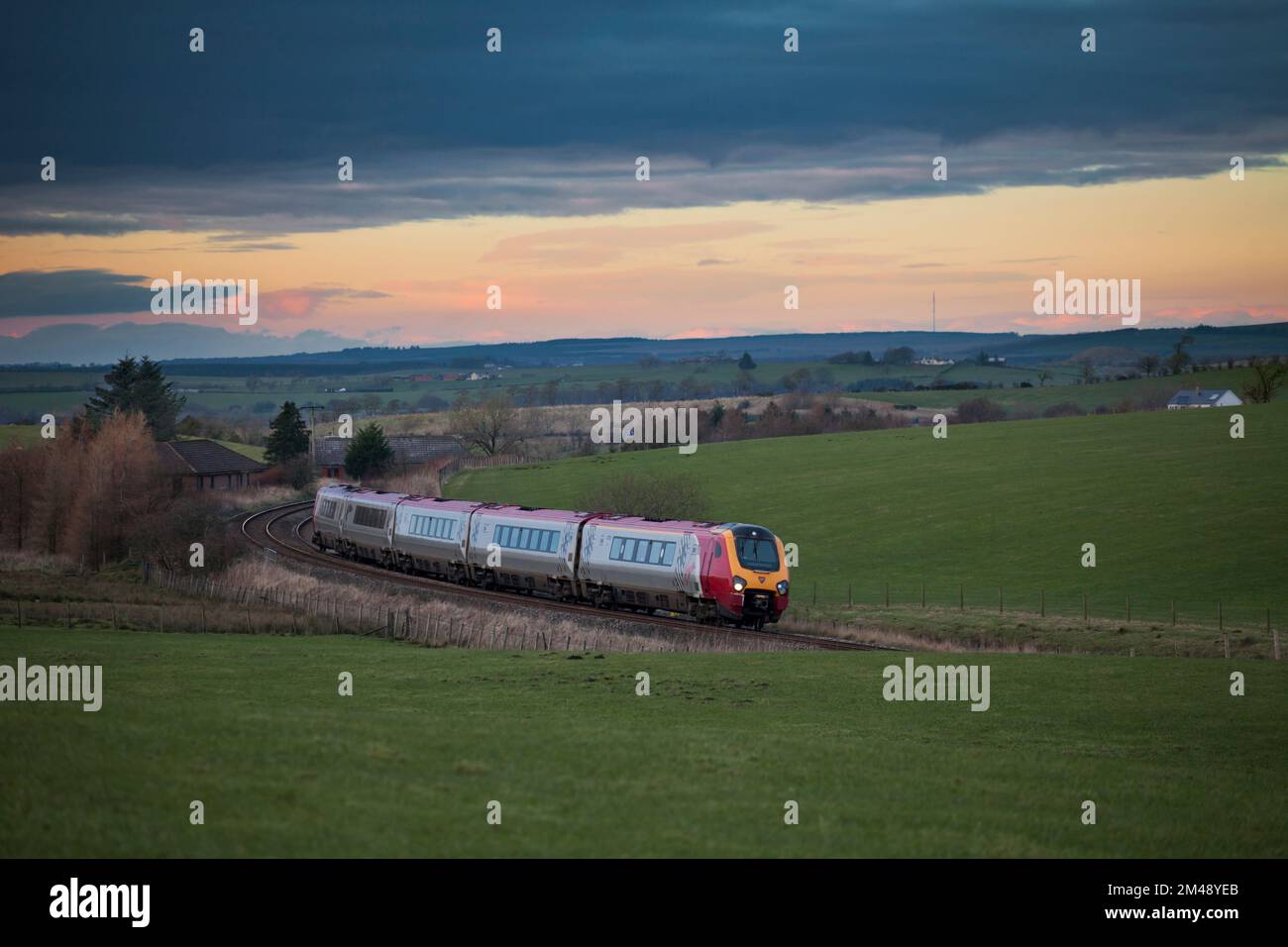 Virgin Trains class 221 voyager train passing Polquip, in rural southern Scotland with a diverted Anglo Scottish train Stock Photo