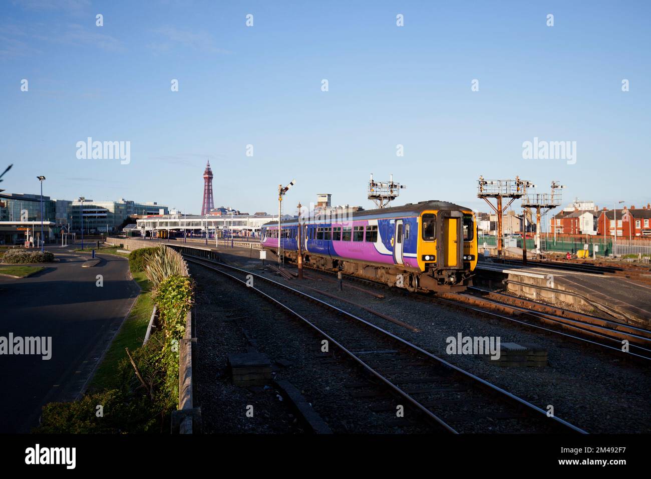 Northern Rail class 156 sprinter train departing from Blackpool North station with the bracket semaphore signals Stock Photo
