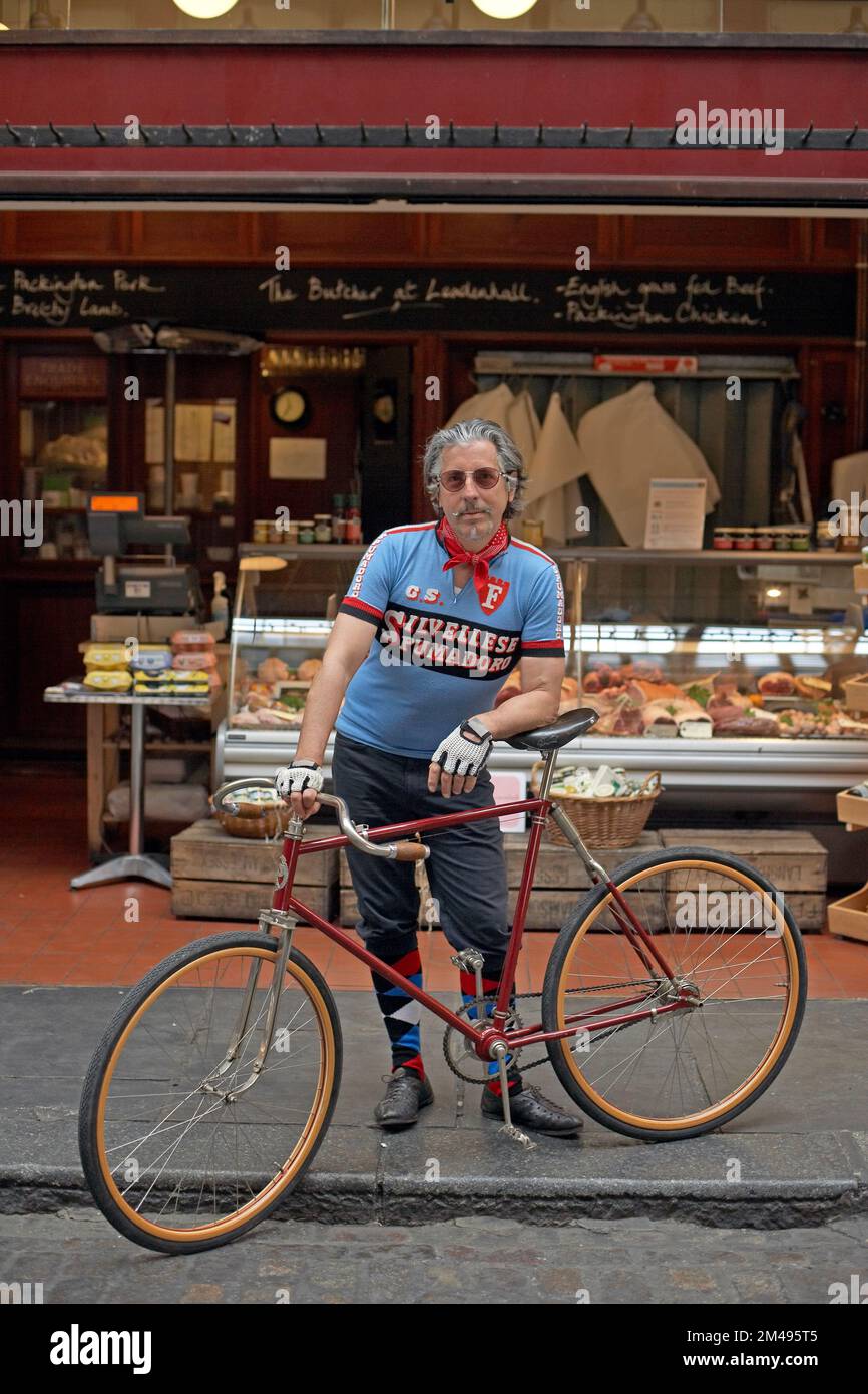 Male with bicycle in front butcher ,London , United Kingdom Stock Photo