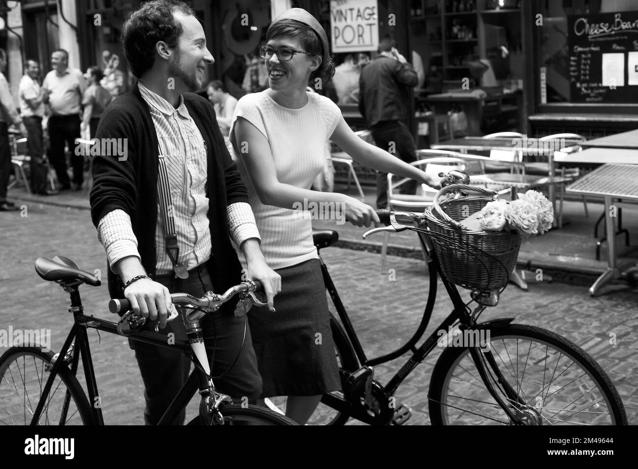 Happy man and woman riding bicycle In London . Happy couple riding bikes in city . Stock Photo