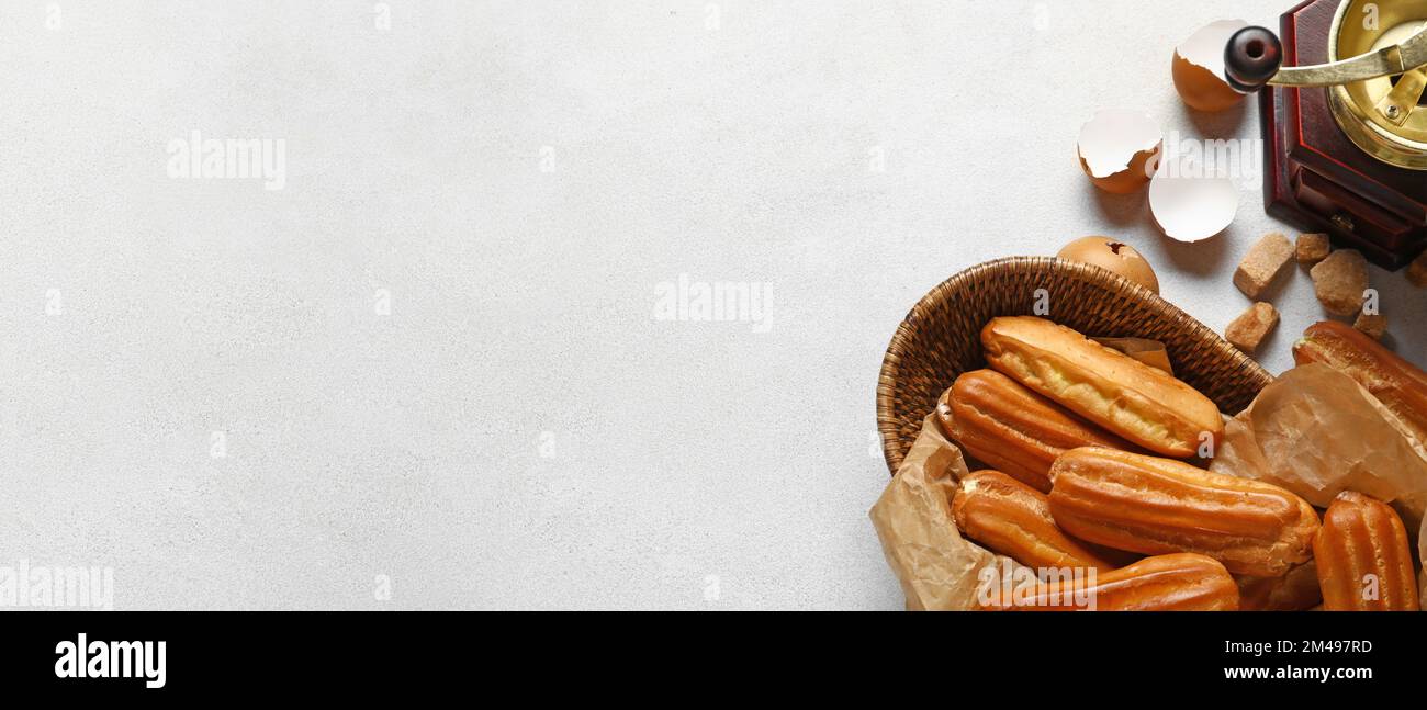 Composition with sweet eclairs on light background with space for text, top view Stock Photo