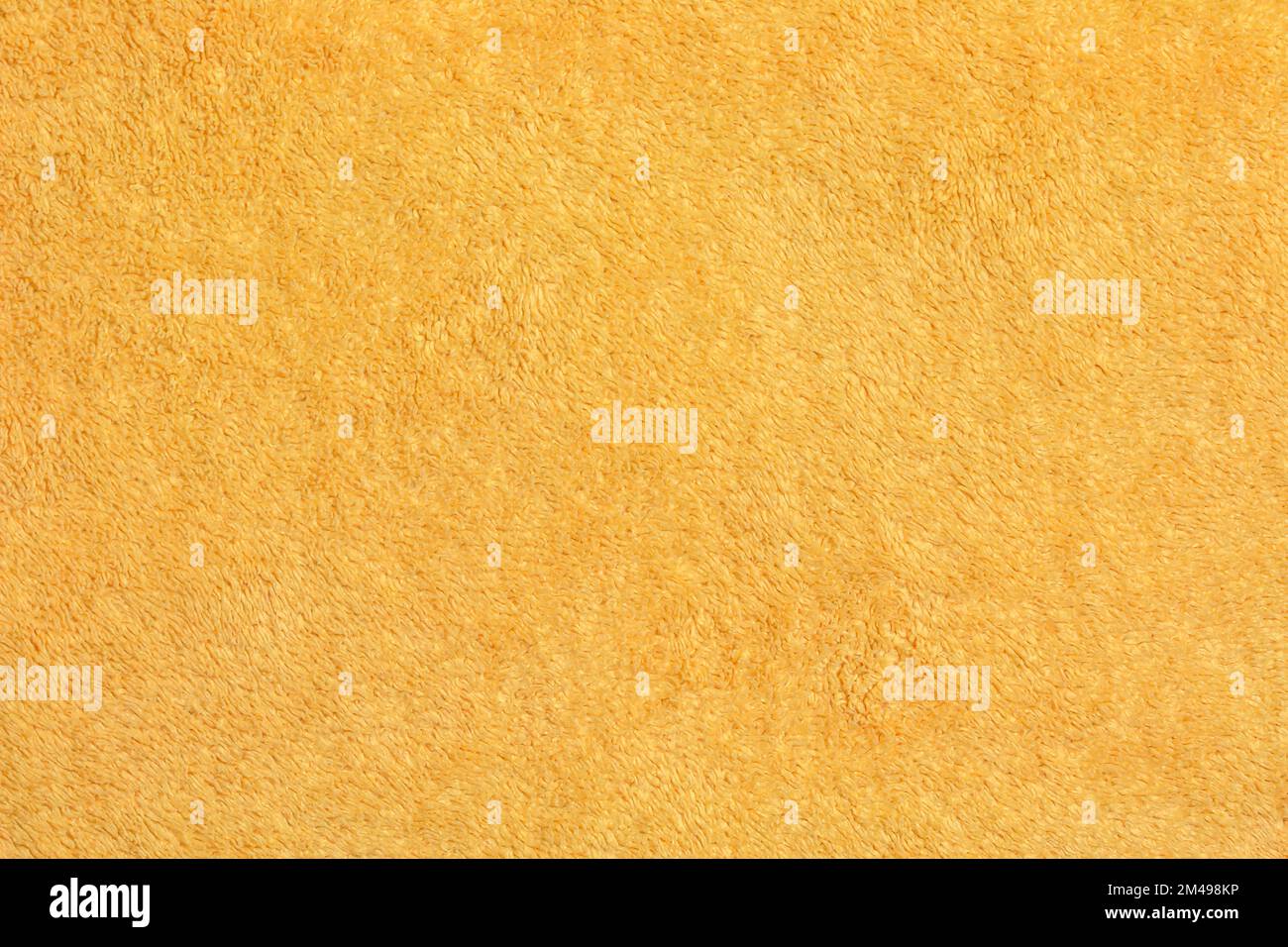 Yellow terry cloth for towels. Yellow fabric and texture concept. Close up terry cloth towel. Stock Photo