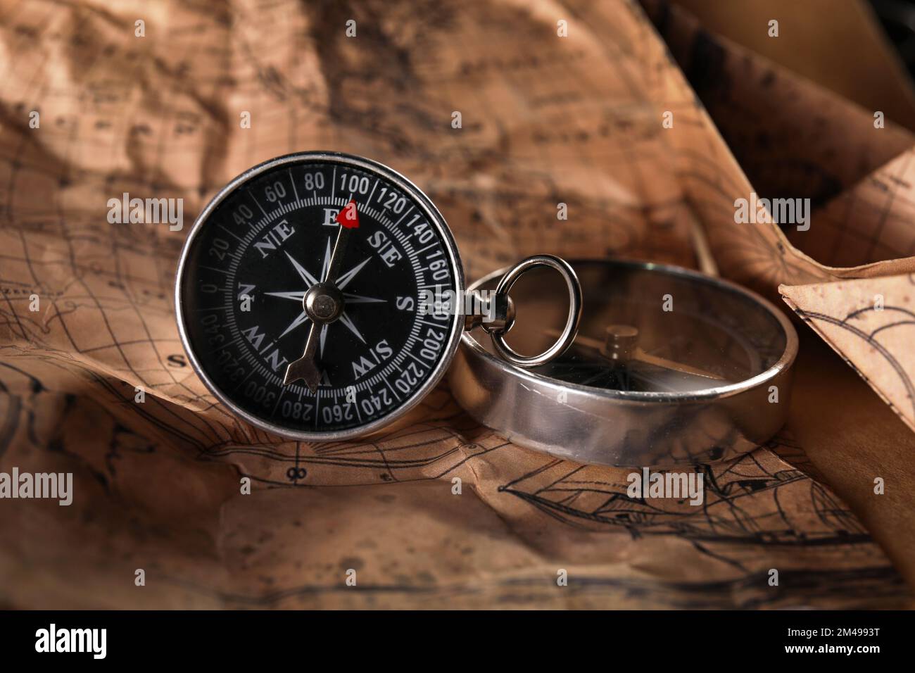 Small compasses on world map Stock Photo Alamy