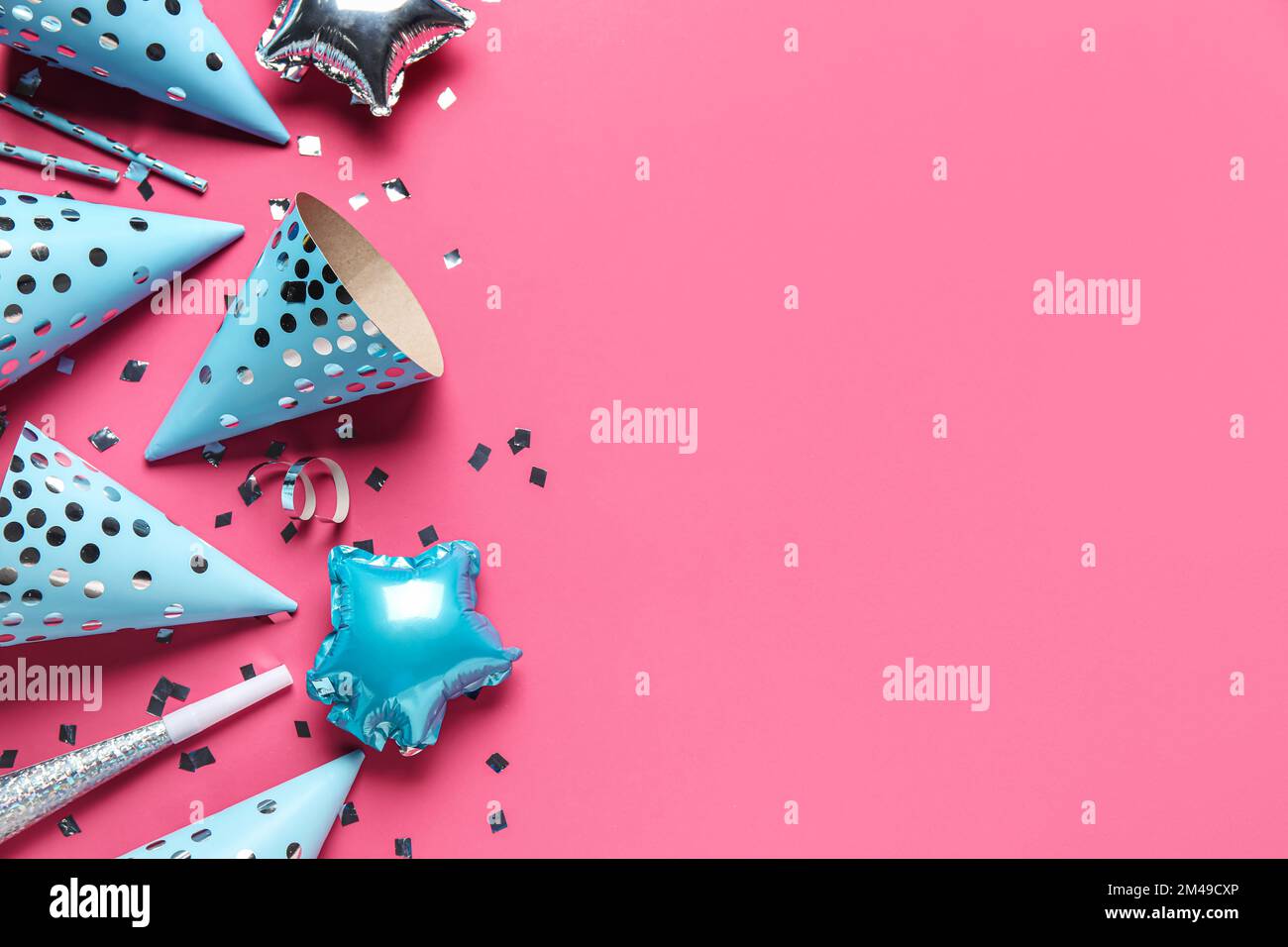 Party hats, confetti and straws on pink background Stock Photo - Alamy