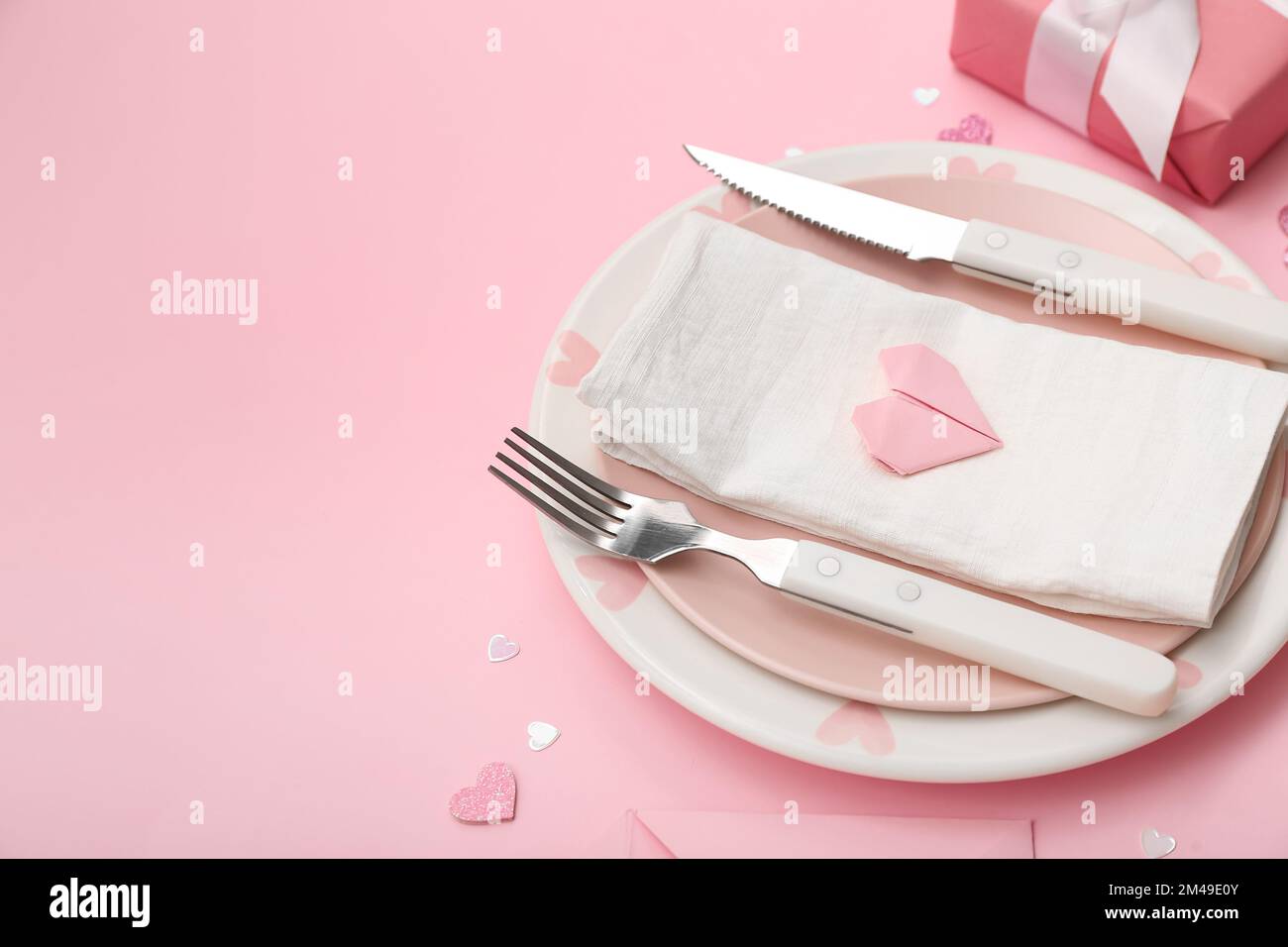 Table setting for Valentine's Day with beautiful hearts on pink ...