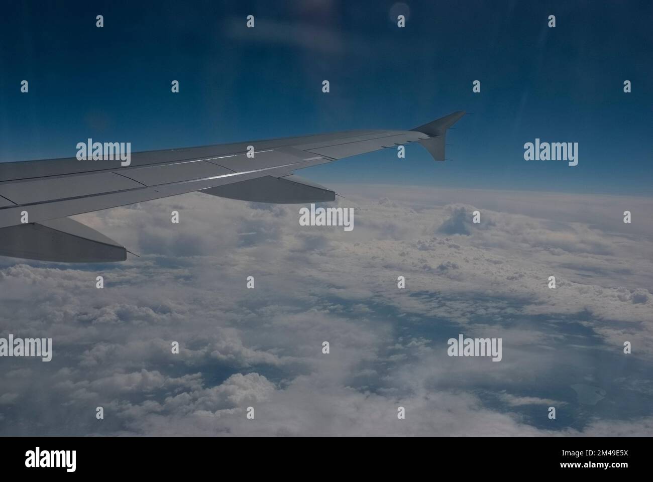Airplane wing above the clouds Stock Photo - Alamy