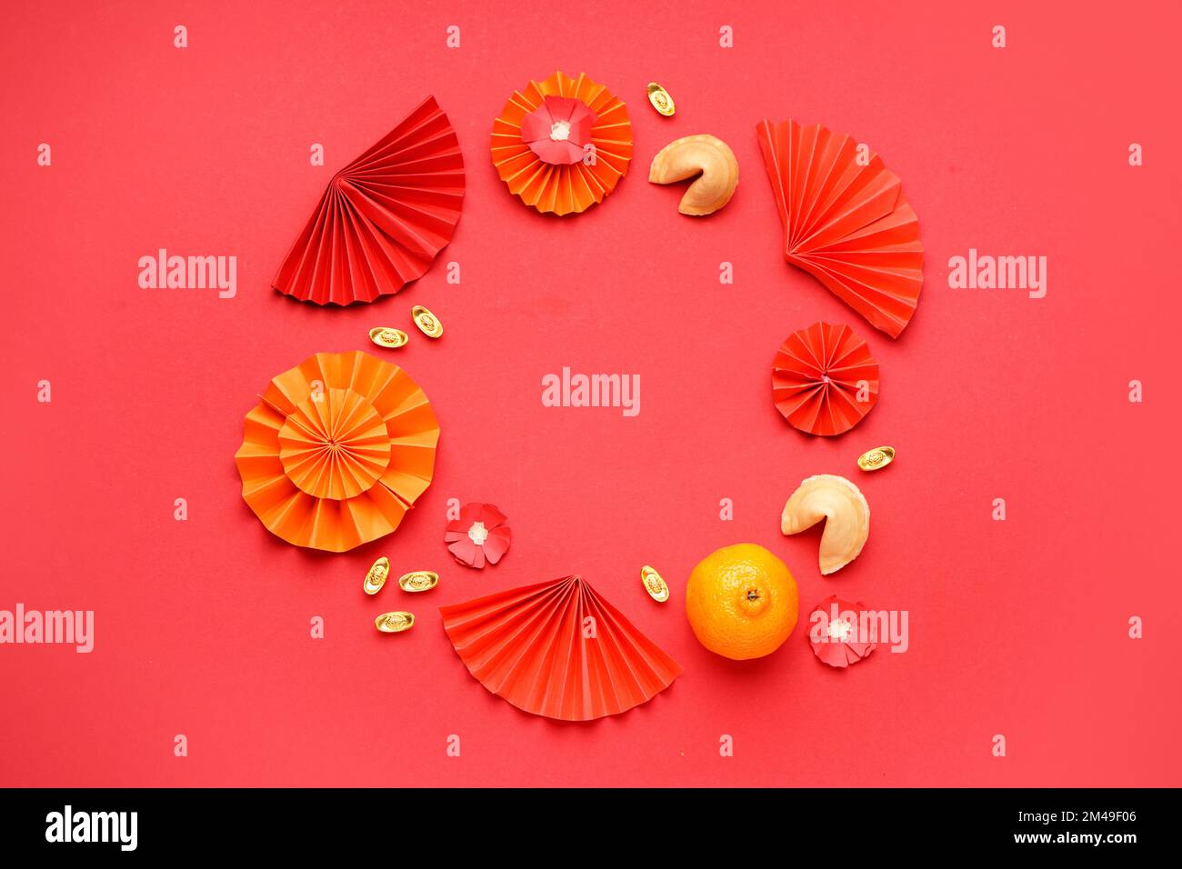 Frame made of mandarin and Chinese symbols on red background. New Year