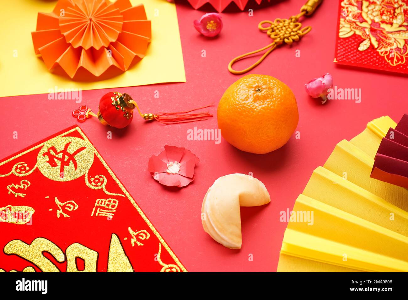 Mandarin, fortune cookie and Chinese symbols on red background. New