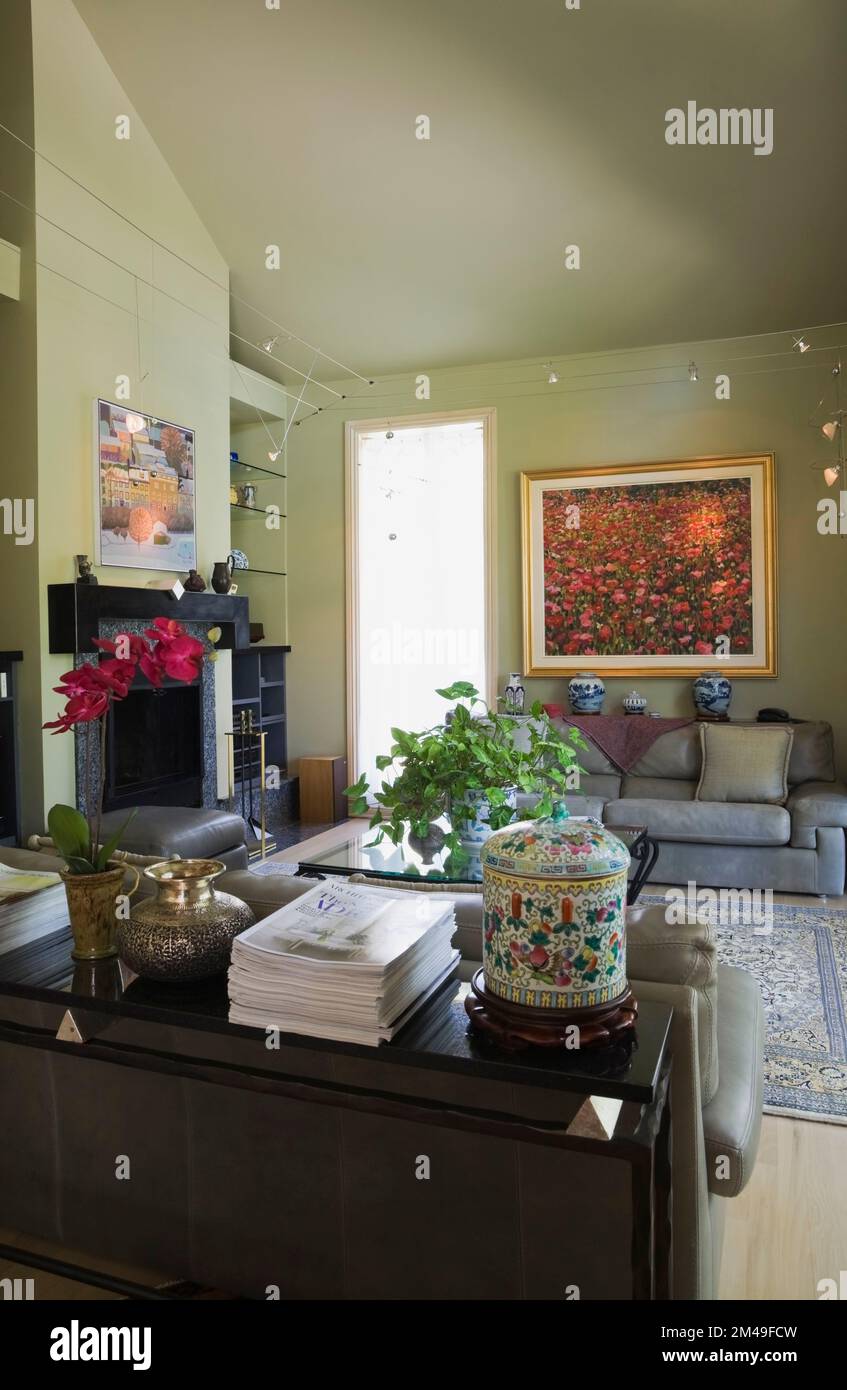 Grey leather sofa and glass top coffee table in living room inside