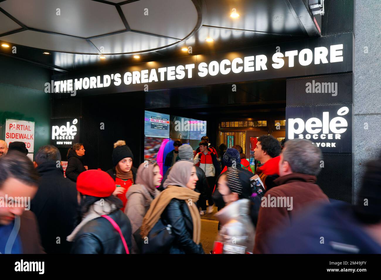 People walking past Pele Soccer sporting goods store in Times Square, New York City, December 14