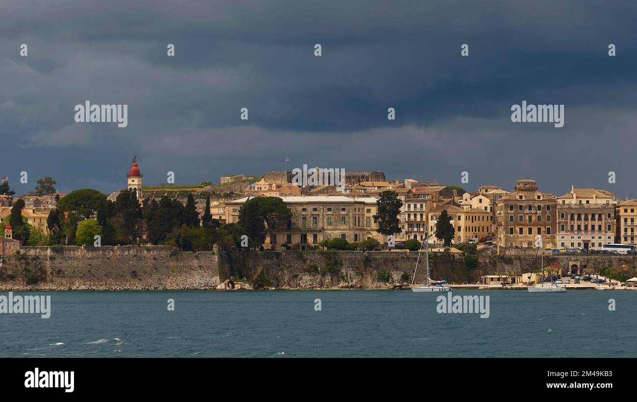 Part of Corfu Town, view from the sea, grey-black dark sky, sailboats, dark sea, arrival and departure by boat, Corfu Island, Ionian Islands, Greece Stock Photo