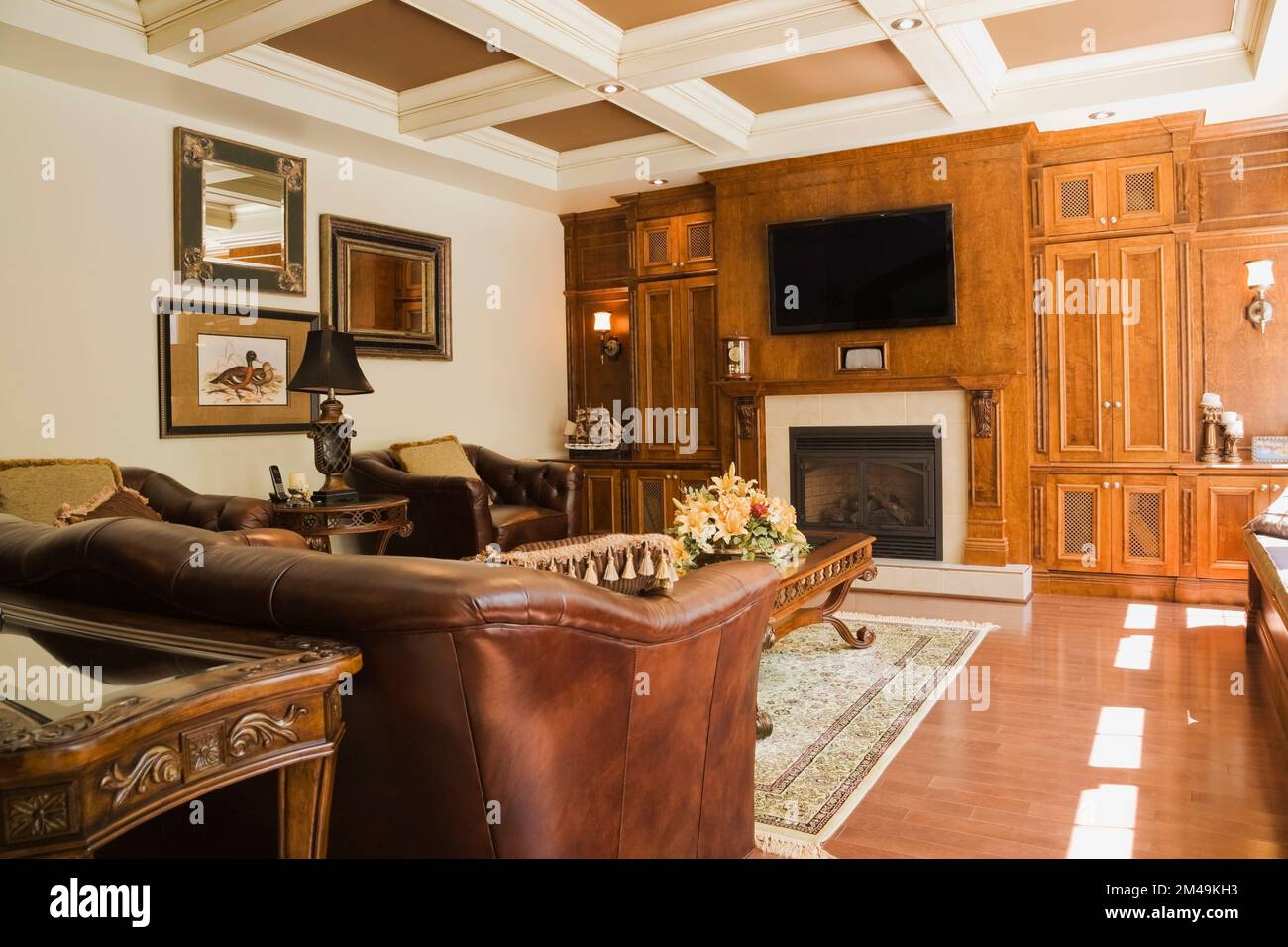 Brown leather sofa and armchair in living room inside lavishly