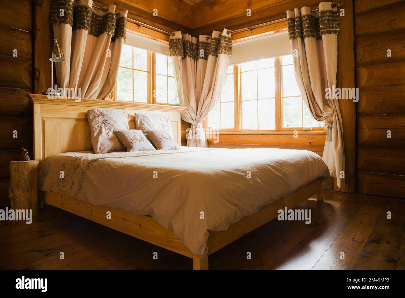 Wood frame double bed with wooden headboard in master bedroom inside log home Stock Photo Alamy