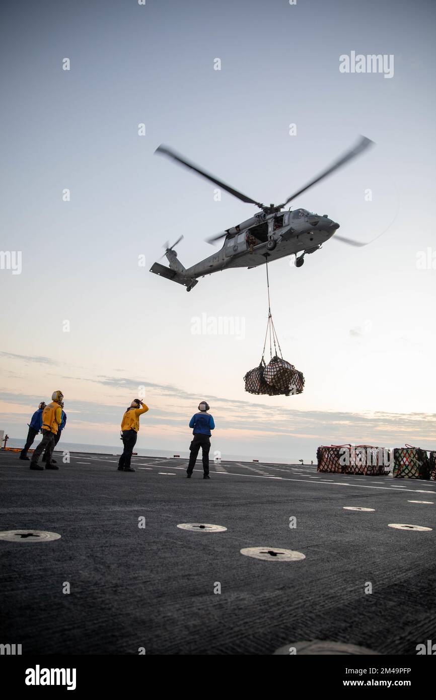 JEREMIE, Haiti (Dec. 17, 2022) Sailors assigned to the hospital ship USNS Comfort (T-AH 20), observe flight operations while an MH60-S Seahawk, attached to the “Chargers” of Helicopter Sea Combat Squadron (HSC) 26, delivers supplies to the medical site in Jeremie, Haiti, Dec. 17, 2022. Comfort is deployed to U.S. 4th Fleet in support of Continuing Promise 2022, a humanitarian assistance and goodwill mission conducting direct medical care, expeditionary veterinary care, and subject matter expert exchanges with five partner nations in the Caribbean, Central and South America. (U.S Army photo by Stock Photo