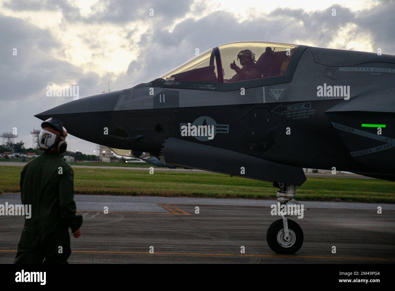 U.S. Marine Corps Cpl. Marco Cardona, an F-35B Lightning II aircraft mechanic with Marine Fighter Attack Squadron 121, guides an F-35B Lightning II aircraft for takeoff during Ryukyu Vice 23.1 at Kadena Air Base, Okinawa, Japan, Dec. 13, 2022. Ryukyu Vice is a joint, fixed-wing aviation command and control exercise that provides critical training to 1st Marine Aircraft Wing tactical air control personnel through offensive, defensive and counter-air live-flight scenarios. (U.S. Marine Corps photo by Lance Cpl. Samantha Rodriguez) Stock Photo