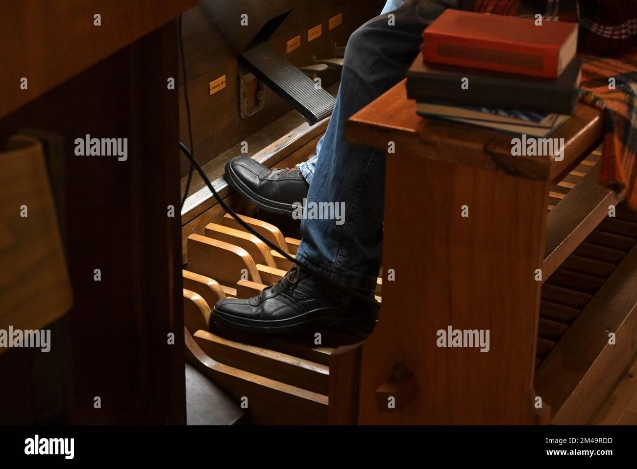 Feet of an organist playing on the organ pedals, traditional musical