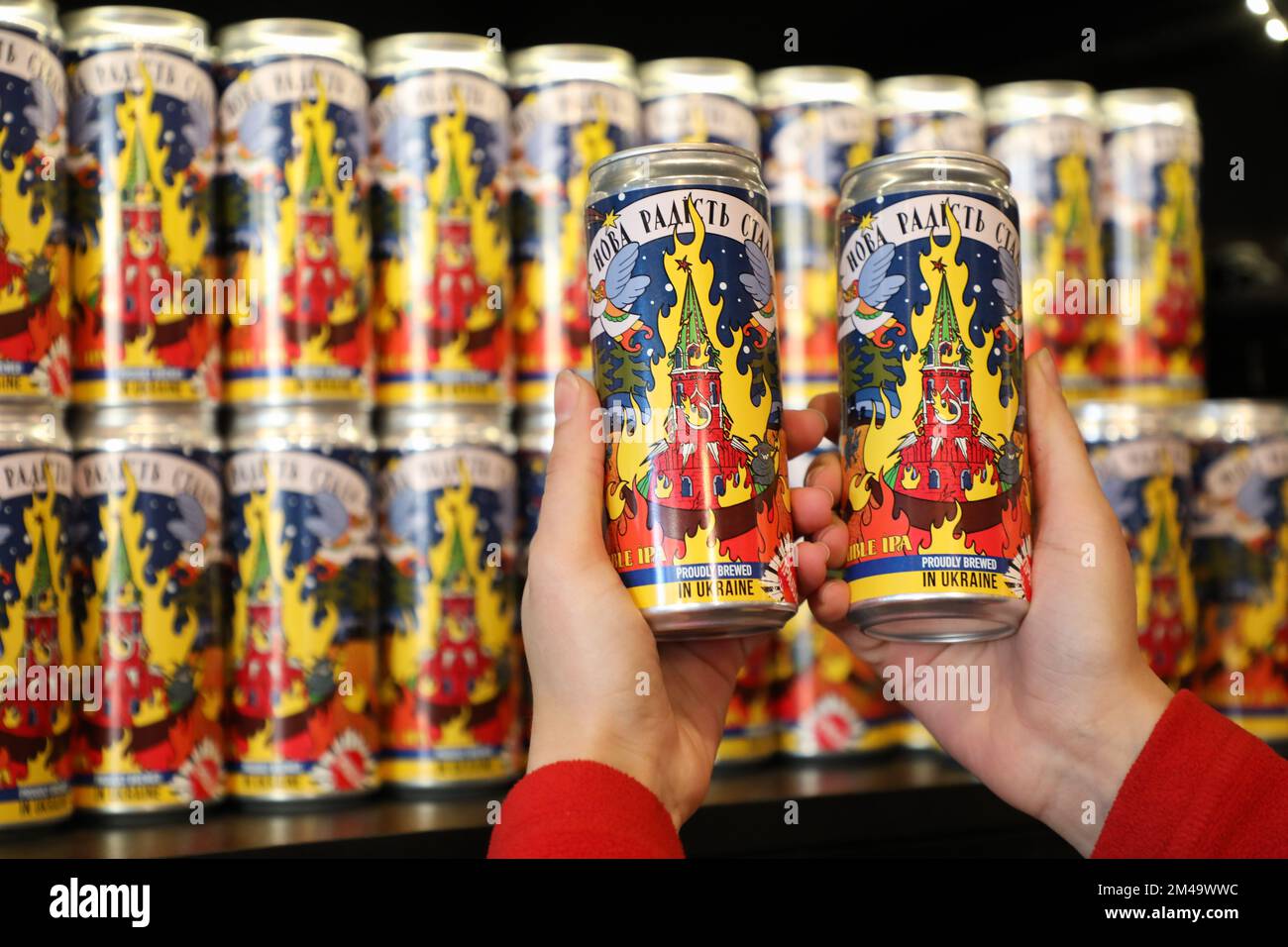Lviv, Ukraine. 19th Dec, 2022. A seller holds new cans of beer produced ...