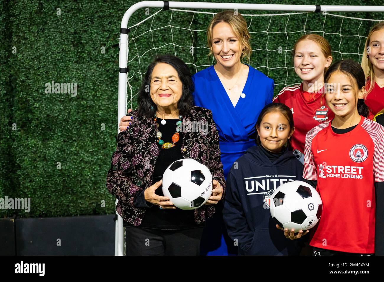 Farmworker civil rights leader and previous inductee Dolores Huerta poses with young soccer players at California Museum's Hall of Fame event. Stock Photo