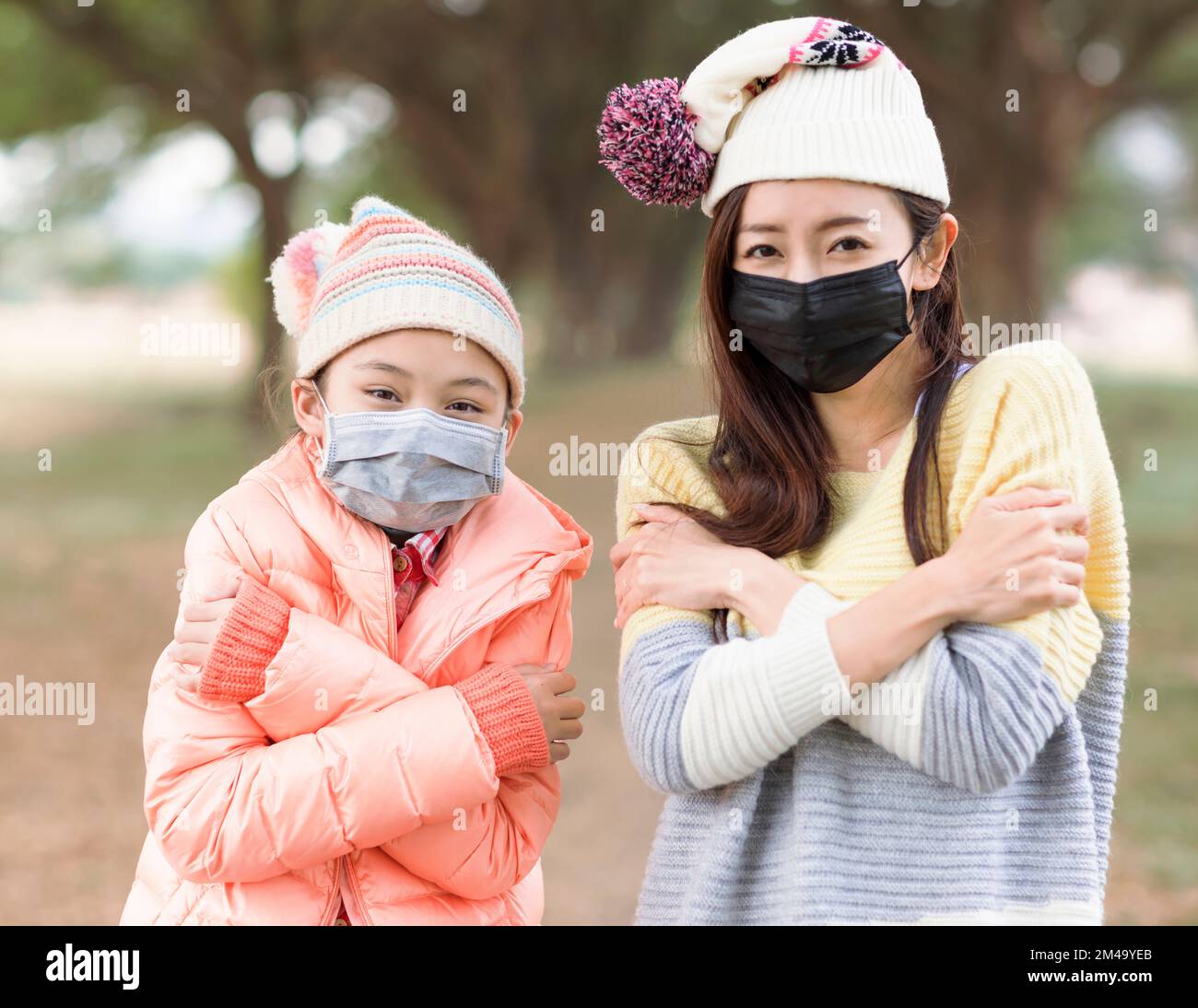 Mother and  daughter wearing face protective medical mask Stock Photo