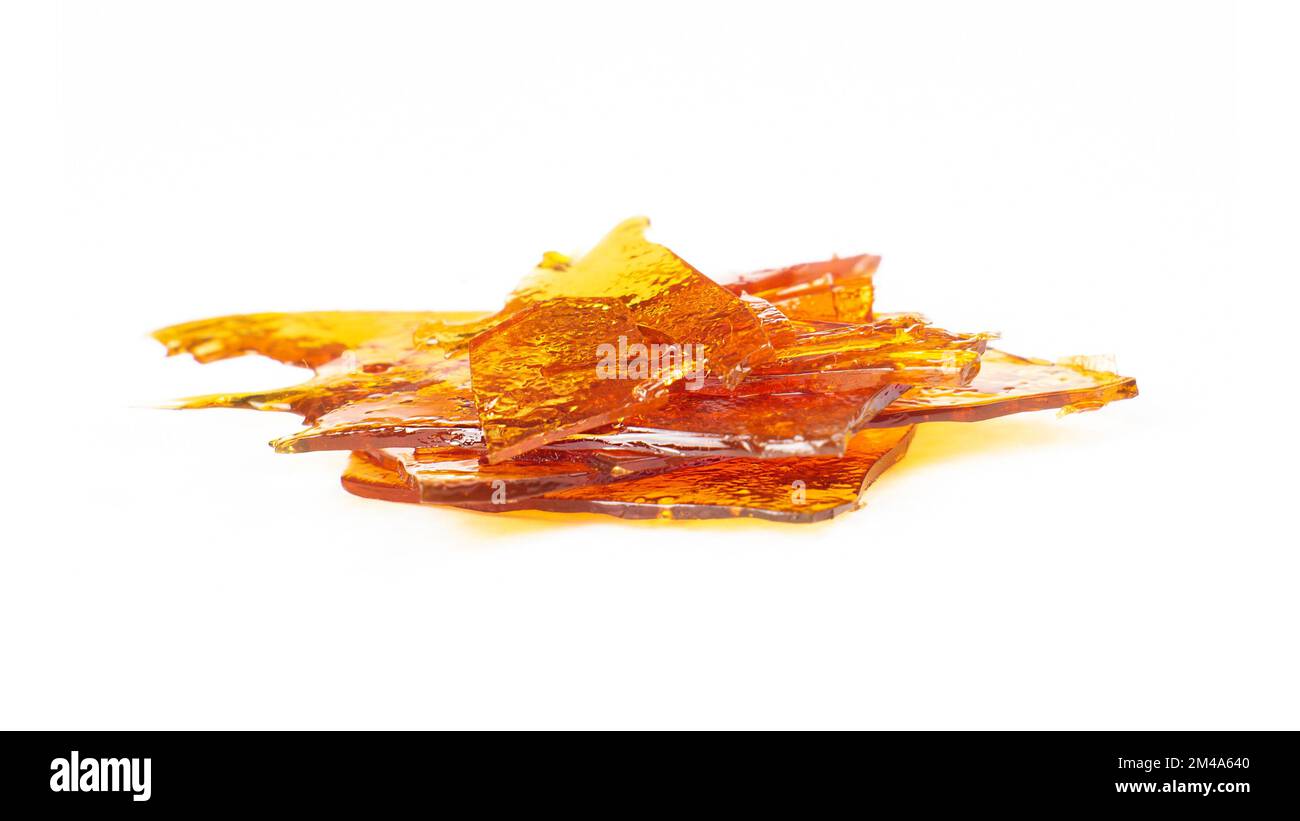 a pieces of cannabis wax closeup isolate on white background