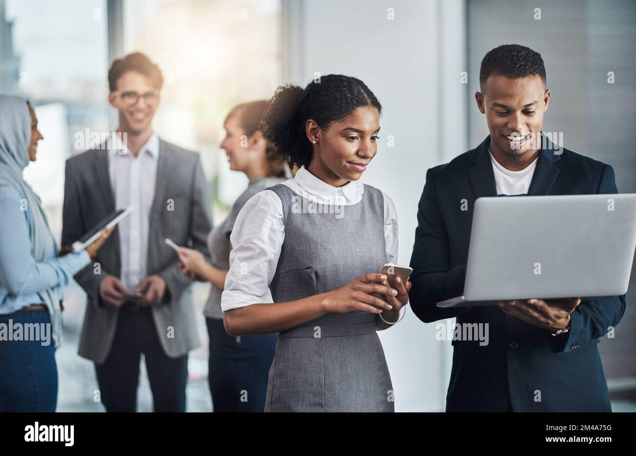 It turned out to be a busy day. a group of young cheerful businesspeople browsing on digital