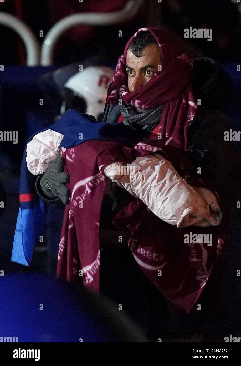 PA REVIEW OF THE YEAR 2022 File photo dated 15/01/22 - A man carries a baby as a group of people thought to be migrants are brought in to Dover, Kent, after being rescued by the RNLI following a small boat incident in the Channel. Issue date: Tuesday December 20, 2022. Stock Photo