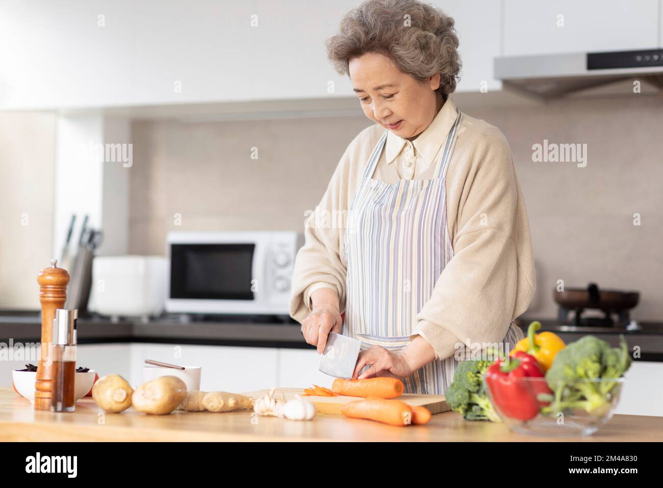 Cheerful Senior Chinese Woman Cooking In Kitchen Stock Photo Alamy old-chinese-woman-cooking-photos-and-premium-high-res-pictures-getty