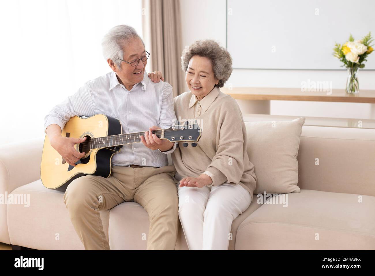 Cheerful senior Chinese couple relaxing at home Stock Photo - Alamy