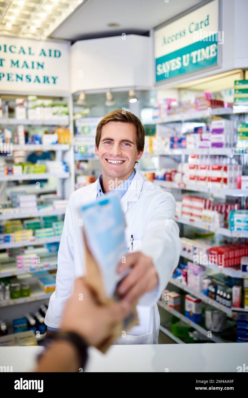 Feel better soon. Personal perspective shot of a pharmacist handing