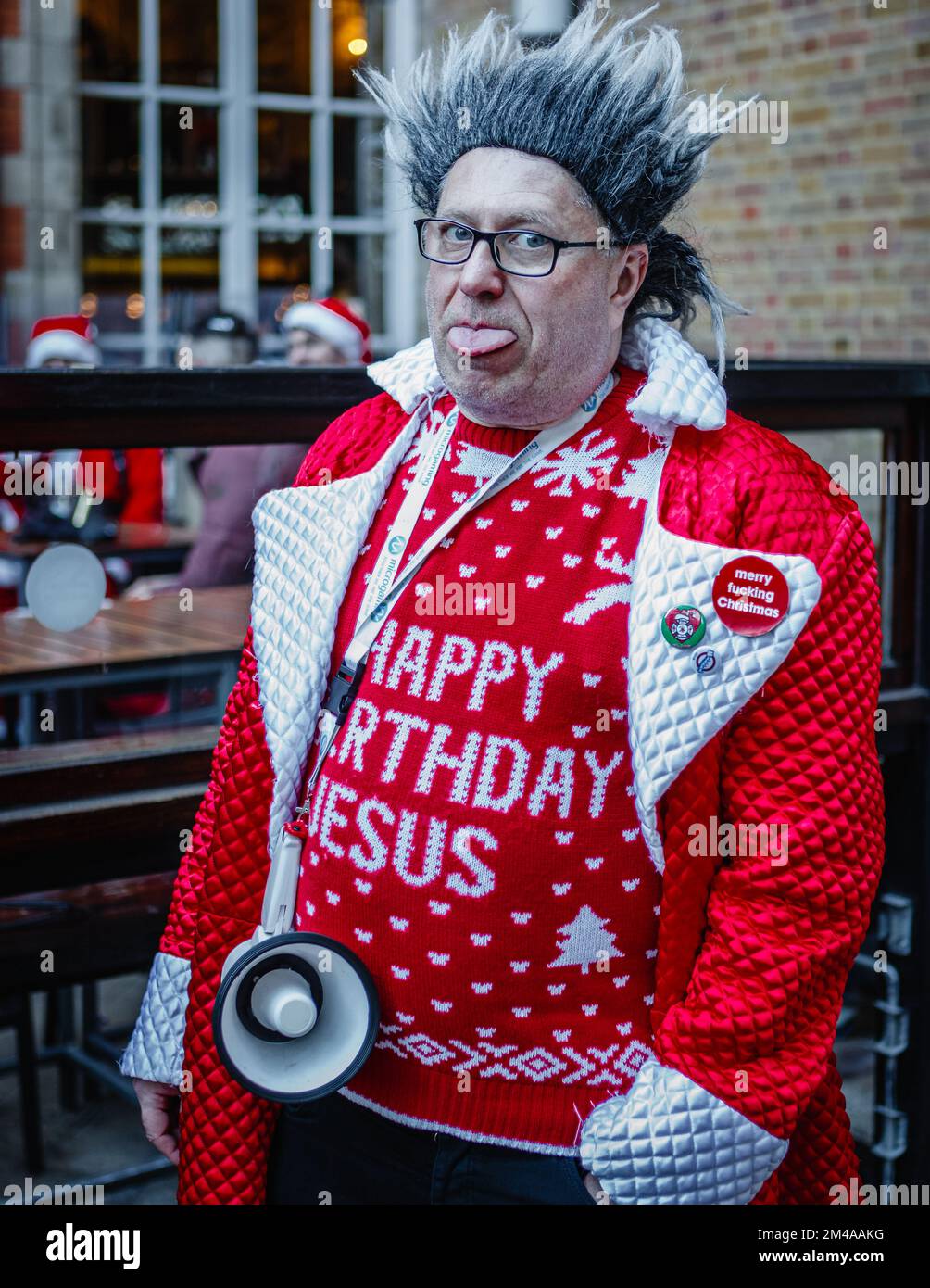 A cheeky spikey haired reveller at the annual santacon event in London. Stock Photo