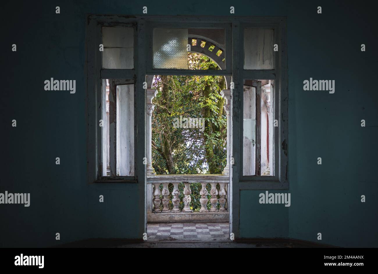 View from abandoned building room through open balcony door Stock Photo