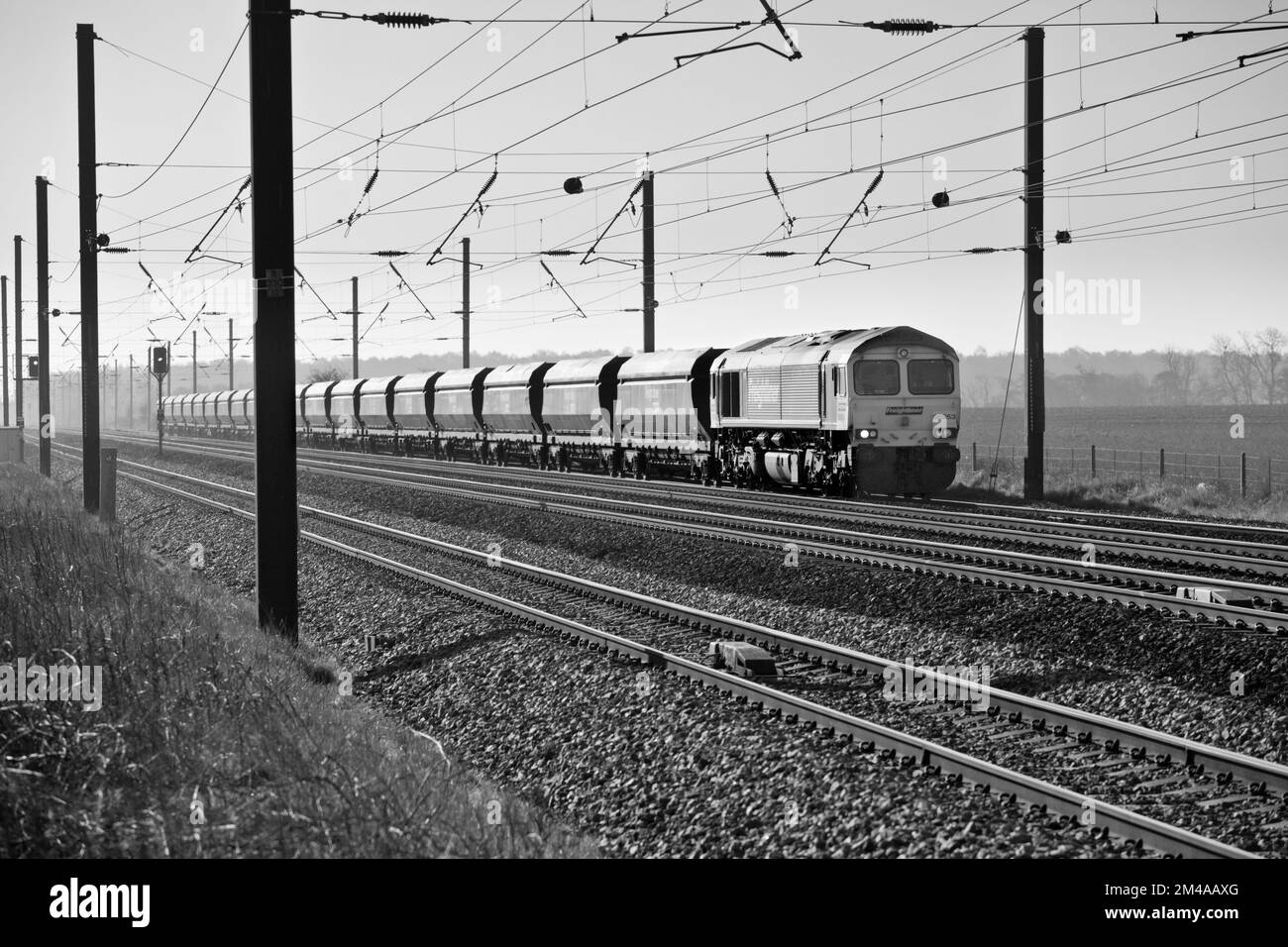 Freightliner class 66 diesel locomotive 66953 hauling an empty merry go round coal train on the electrified east coast mainline in Yorkshire Stock Photo