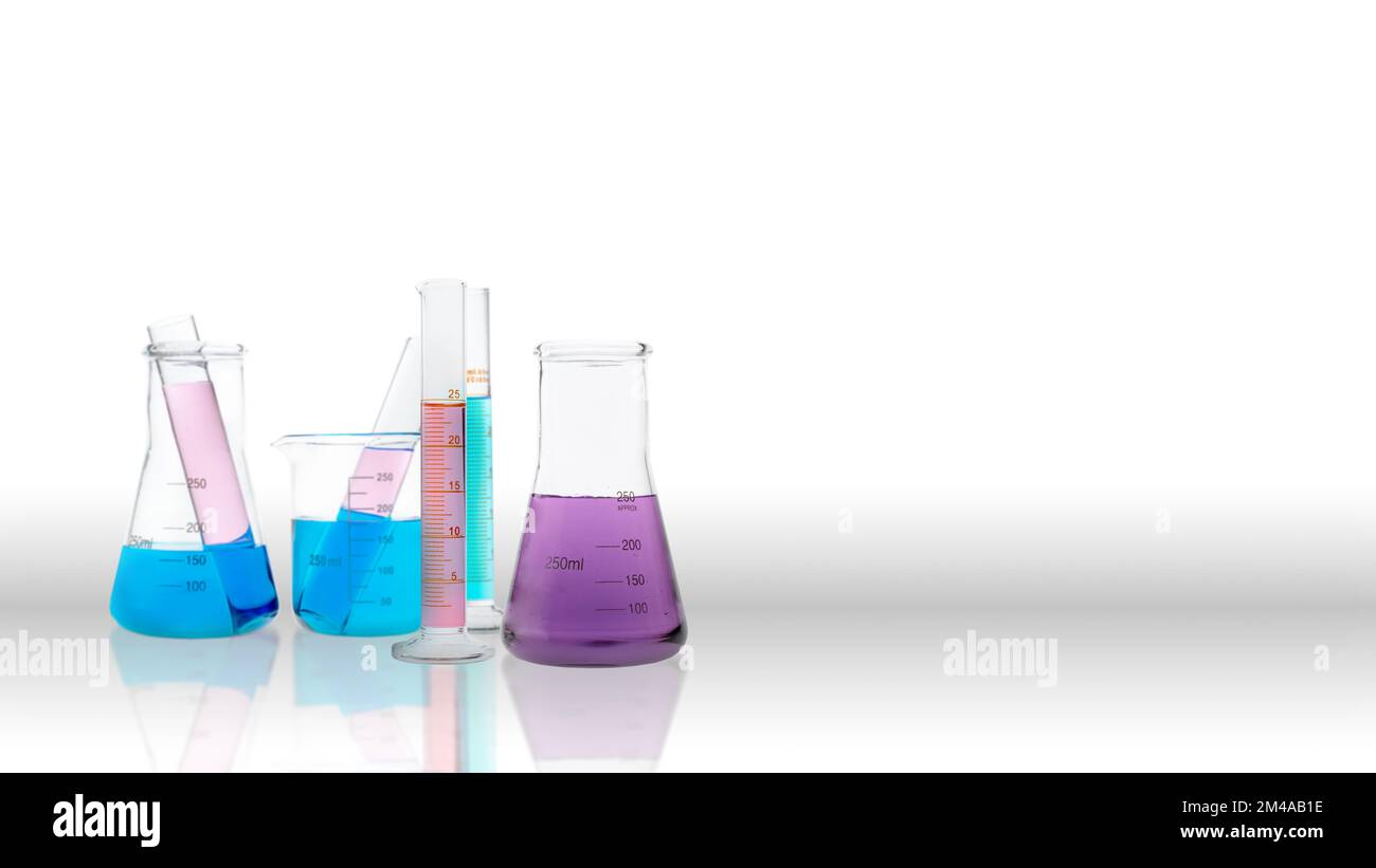 Colorful chemicals in laboratory glassware on a colored background